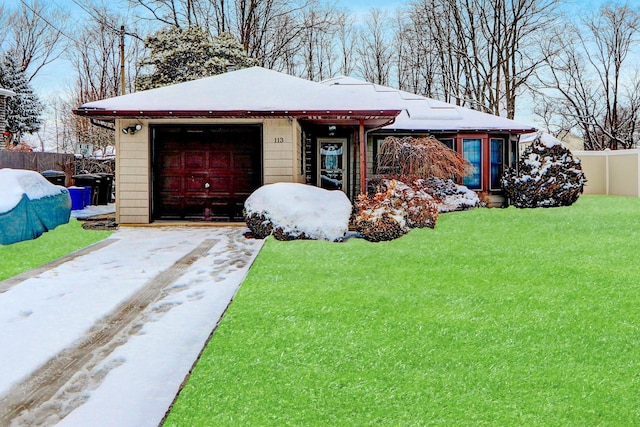 view of front facade with a garage and a yard