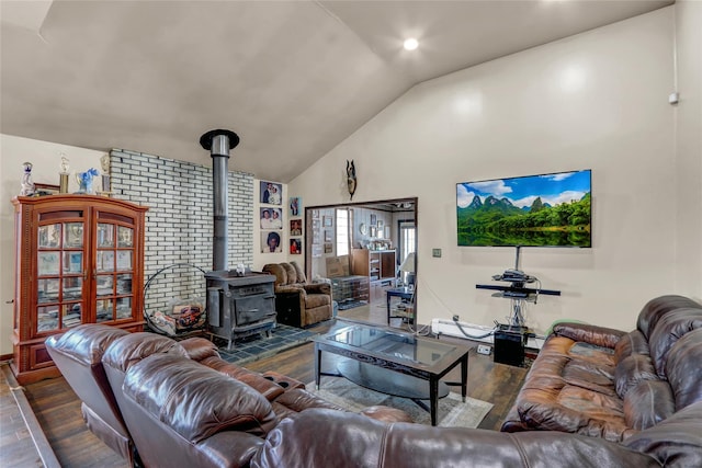 living room with high vaulted ceiling, dark hardwood / wood-style floors, and a wood stove