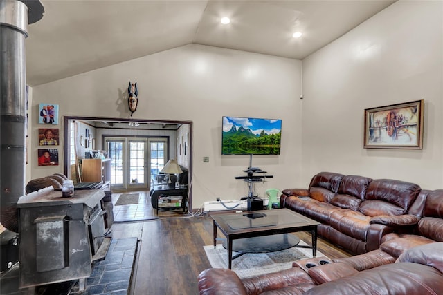 living room featuring a wood stove, dark wood-type flooring, high vaulted ceiling, and french doors