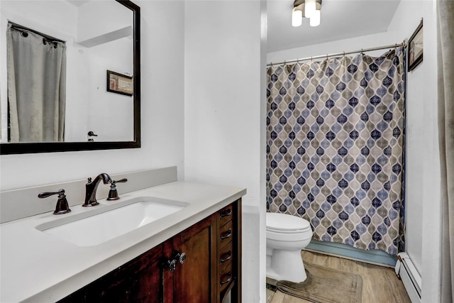 bathroom featuring a shower with curtain, vanity, toilet, and a baseboard heating unit