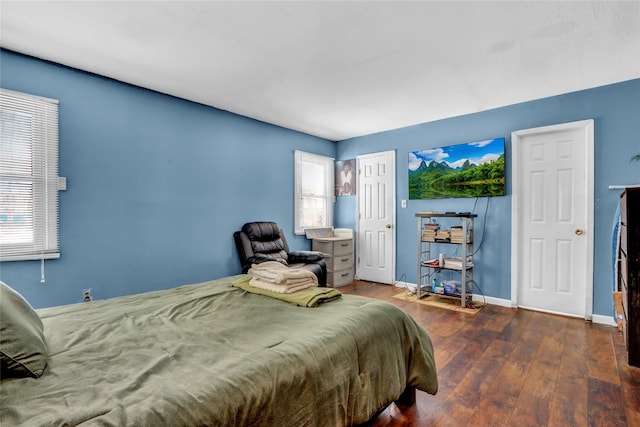 bedroom with dark hardwood / wood-style floors