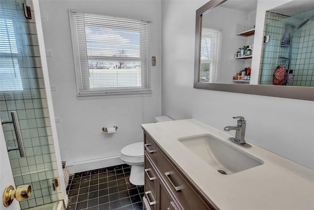 bathroom with a healthy amount of sunlight, toilet, a shower with shower door, and vanity