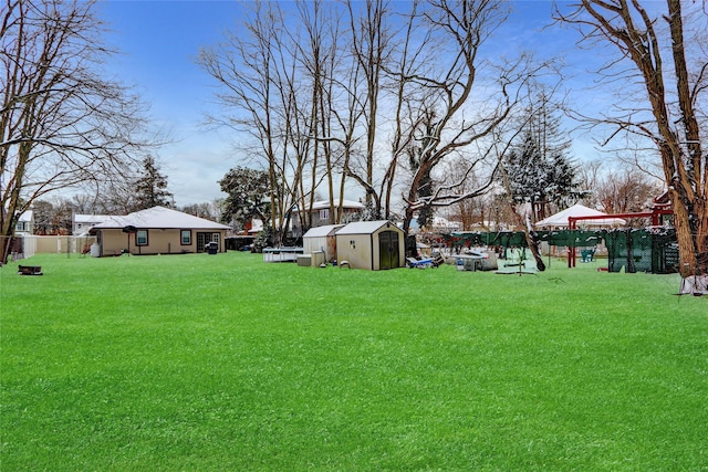 view of yard featuring a storage shed and a playground