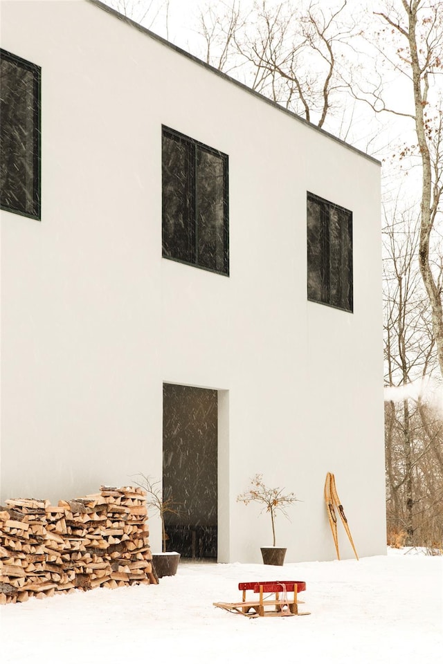 rear view of property featuring stucco siding