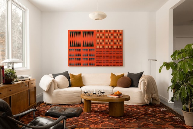 sitting room with baseboards and a wealth of natural light