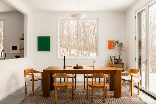 dining area with baseboards and a healthy amount of sunlight