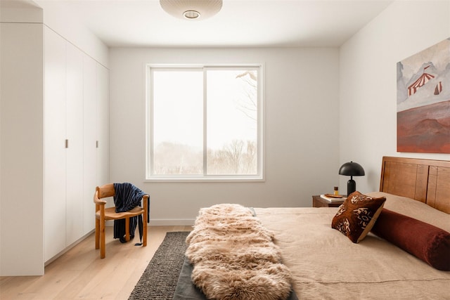 bedroom with a closet and light wood-style flooring