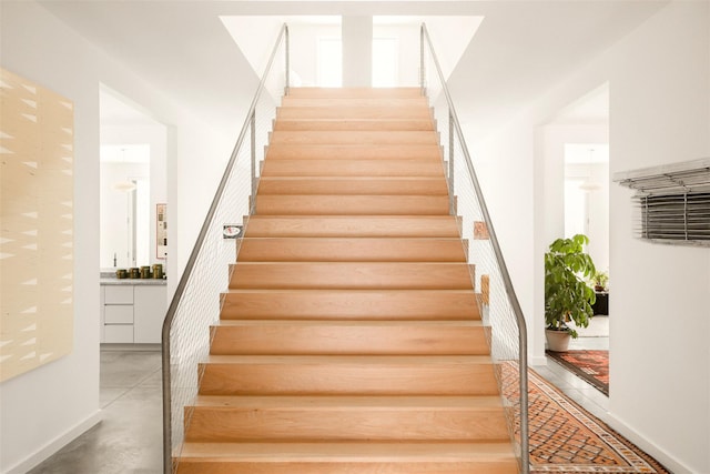 staircase with finished concrete floors