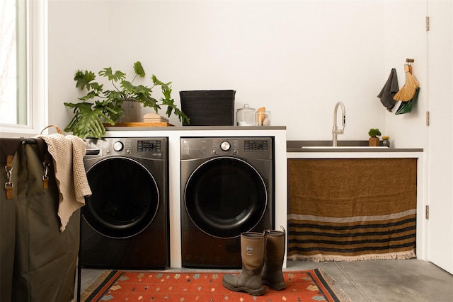 laundry area featuring laundry area, a sink, and washer and dryer