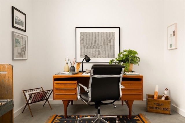 office with finished concrete floors and baseboards