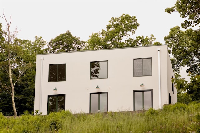 rear view of house with stucco siding