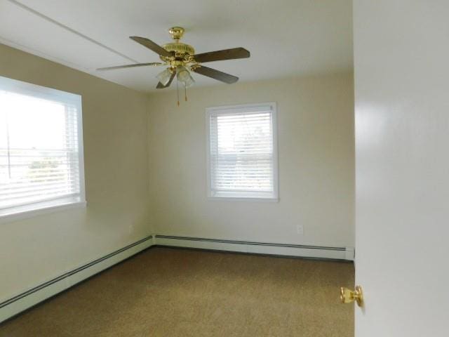 carpeted spare room featuring ceiling fan, a baseboard radiator, and a healthy amount of sunlight