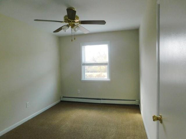 carpeted spare room featuring a baseboard heating unit and ceiling fan