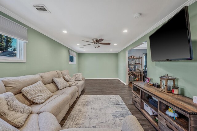 living room with dark wood-style flooring, recessed lighting, visible vents, ornamental molding, and baseboards