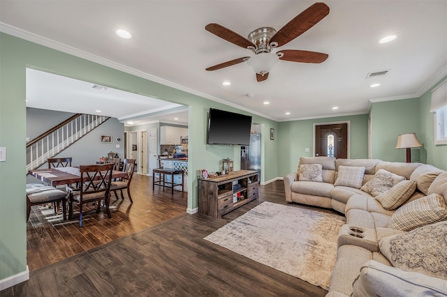 living room featuring dark wood-style floors, recessed lighting, visible vents, and stairway