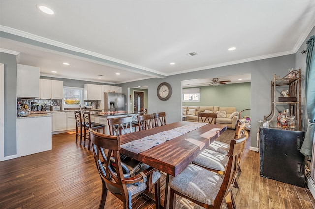 dining area featuring ornamental molding, wood finished floors, and visible vents