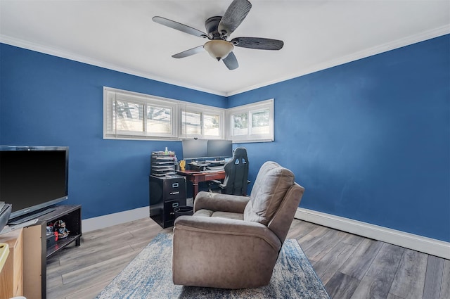 home office with a ceiling fan, crown molding, baseboards, and wood finished floors