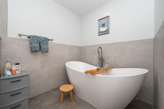 full bathroom with a freestanding bath and tile walls