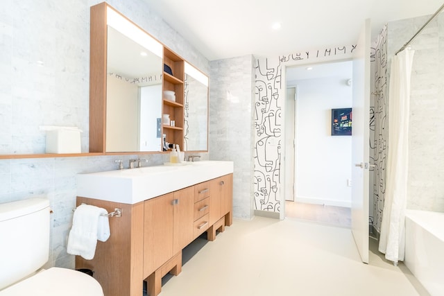 full bathroom with vanity, tile walls, shower / tub combo, and toilet