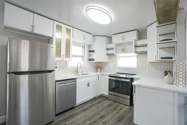 kitchen featuring tasteful backsplash, white cabinetry, sink, stainless steel appliances, and light stone countertops