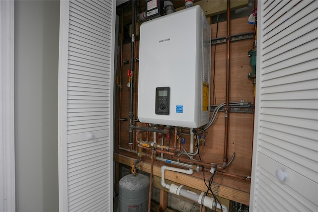 utility room featuring tankless water heater