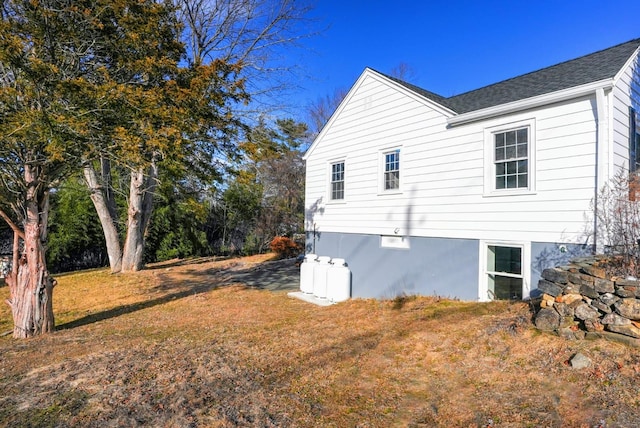 view of side of home with a lawn