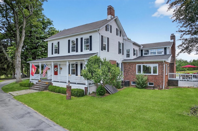 50 Maple Ave, Goshen, NY 10924 - view of front of home featuring covered porch, a chimney, and a front lawn