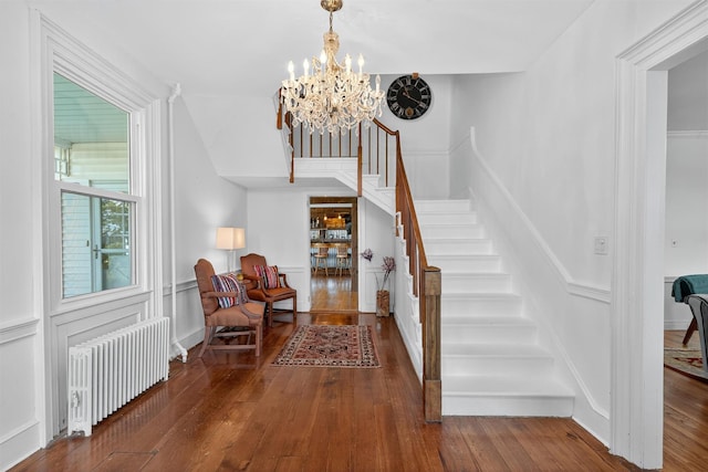 50 Maple Ave, Goshen, NY 10924 - foyer entrance with radiator, a chandelier, hardwood / wood-style floors, and stairs