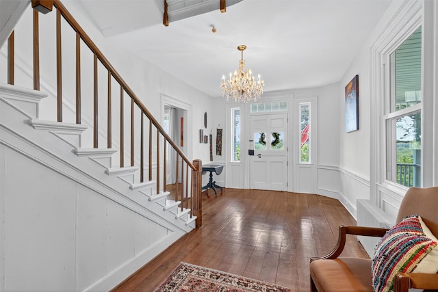 50 Maple Ave, Goshen, NY 10924 - foyer entrance with a chandelier, hardwood / wood-style floors, stairs, and a wainscoted wall