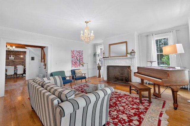 50 Maple Ave, Goshen, NY 10924 - living room featuring a chandelier, wood-type flooring, crown molding, and a fireplace