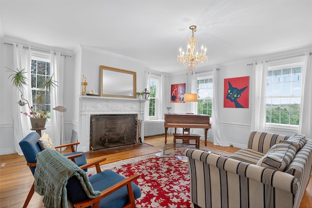 50 Maple Ave, Goshen, NY 10924 - living room featuring radiator heating unit, wood finished floors, plenty of natural light, and crown molding