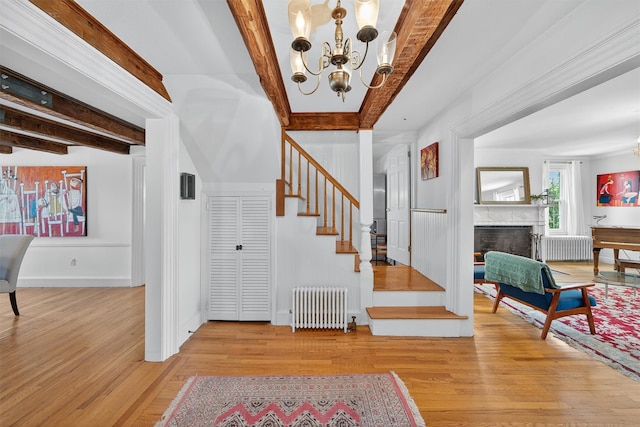 50 Maple Ave, Goshen, NY 10924 - foyer entrance with radiator heating unit, beamed ceiling, a chandelier, and stairway