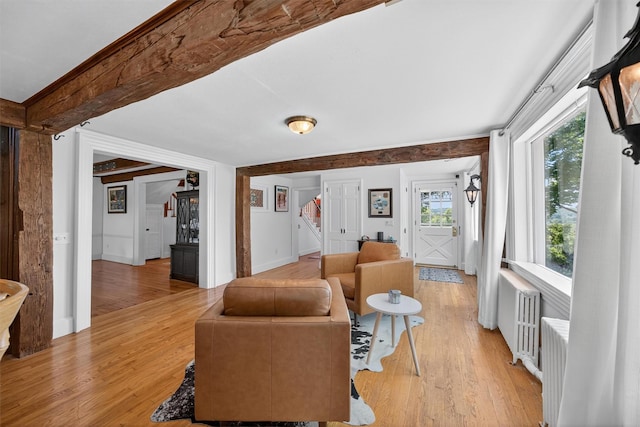 50 Maple Ave, Goshen, NY 10924 - living area featuring stairway, light wood finished floors, radiator heating unit, and beamed ceiling