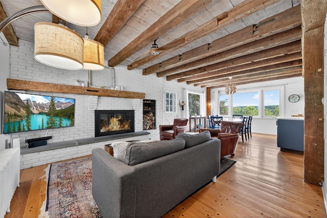 50 Maple Ave, Goshen, NY 10924 - living area with a brick fireplace, wood-type flooring, and a wooden ceiling with exposed beams