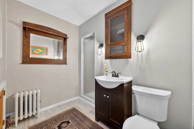 50 Maple Ave, Goshen, NY 10924 - bathroom with radiator heating unit, vanity, a stall shower, and wood finished floors