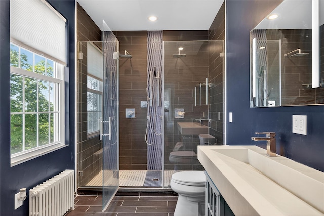 50 Maple Ave, Goshen, NY 10924 - full bath featuring radiator, plenty of natural light, a shower stall, vanity, and recessed lighting