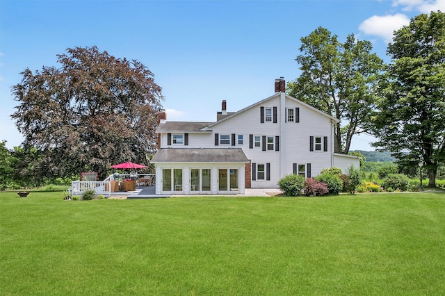 50 Maple Ave, Goshen, NY 10924 - back of house with a lawn, a chimney, and a patio