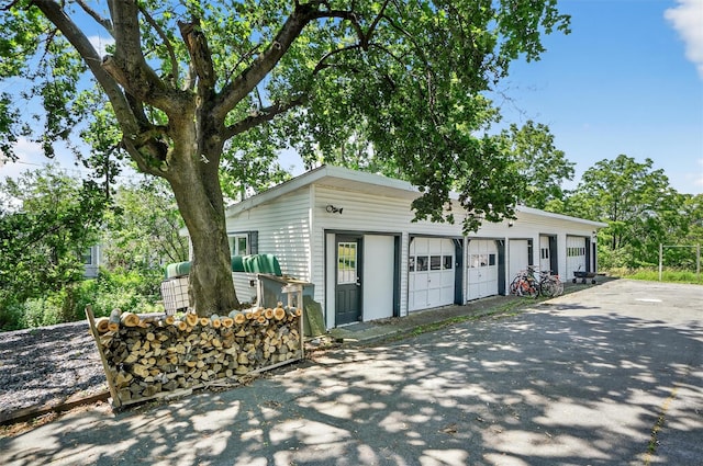 50 Maple Ave, Goshen, NY 10924 - view of front facade featuring an outdoor structure, a garage, and asphalt driveway