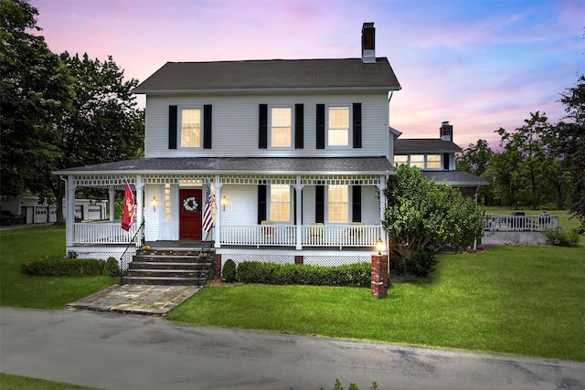 50 Maple Ave, Goshen, NY 10924 - view of front of home with covered porch, a chimney, and a yard