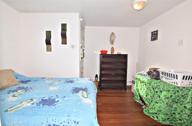 bedroom featuring dark wood-style floors and baseboard heating