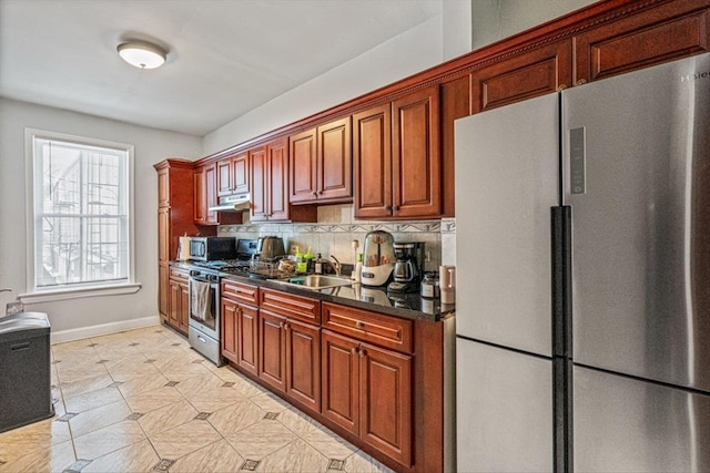 kitchen featuring tasteful backsplash, appliances with stainless steel finishes, and sink