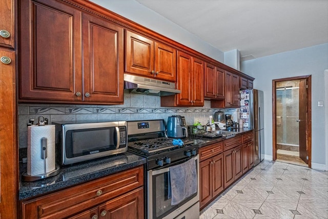 kitchen with backsplash, stainless steel appliances, and dark stone countertops