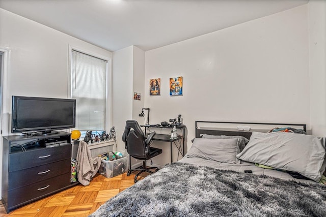 bedroom featuring parquet flooring