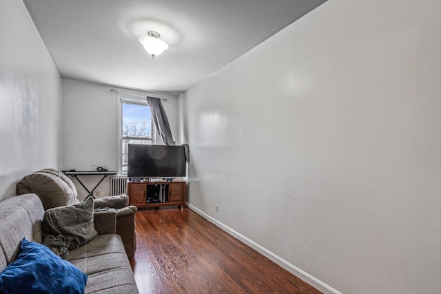 living room featuring dark wood-type flooring and radiator