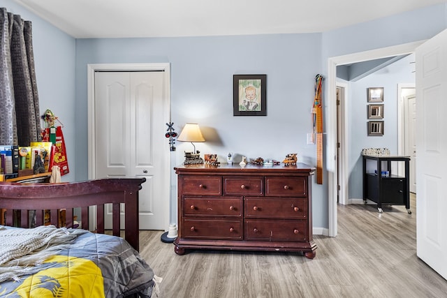 bedroom featuring light hardwood / wood-style floors and a closet