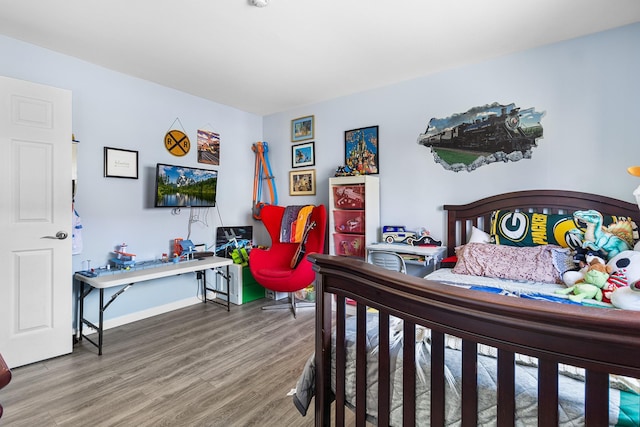 bedroom with hardwood / wood-style flooring