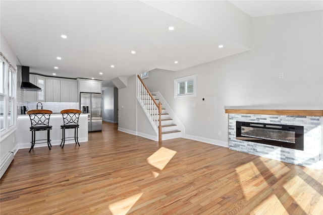 living room featuring a fireplace and light hardwood / wood-style flooring