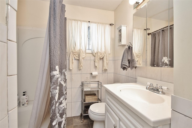 bathroom featuring toilet, a shower with curtain, and tile walls