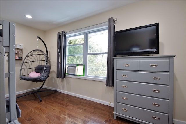 interior space with dark wood-style flooring, cooling unit, and baseboards