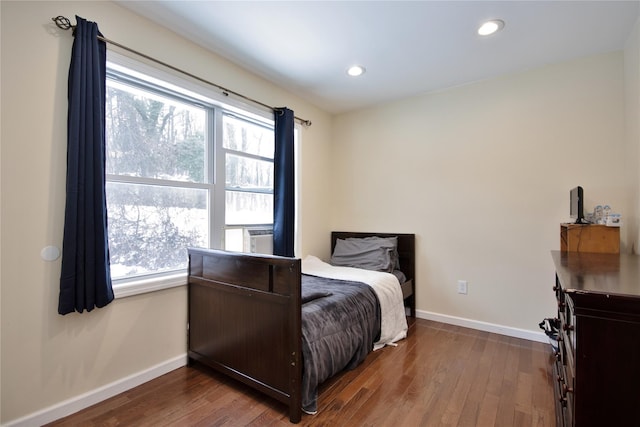 bedroom with dark wood-type flooring, recessed lighting, and baseboards